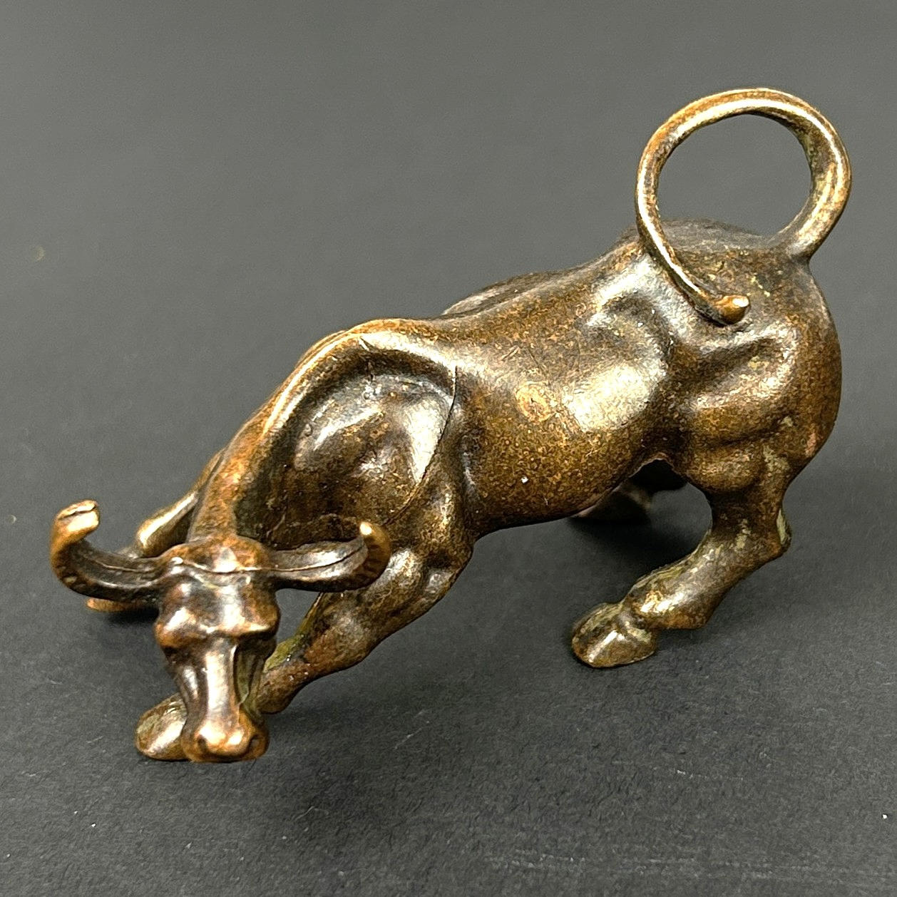 A SMALL BRONZE FIGURE OF A BULL